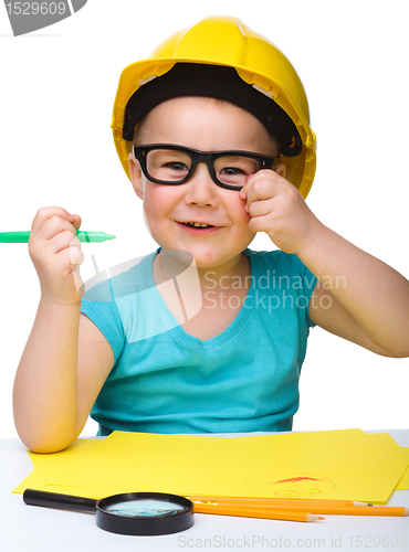 Image of Cute little girl draw with marker wearing hard hat