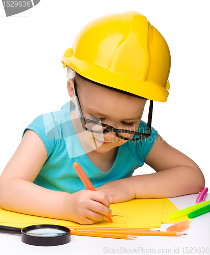 Image of Cute little girl draw with marker wearing hard hat