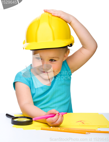 Image of Cute little girl draw with marker wearing hard hat