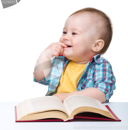 Image of Little child play with book