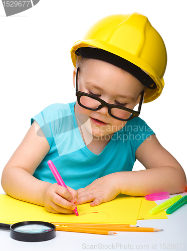 Image of Cute little girl draw with marker wearing hard hat
