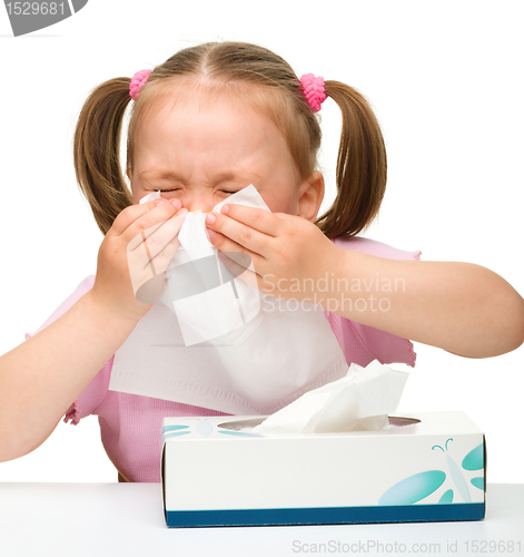 Image of Little girl blows her nose