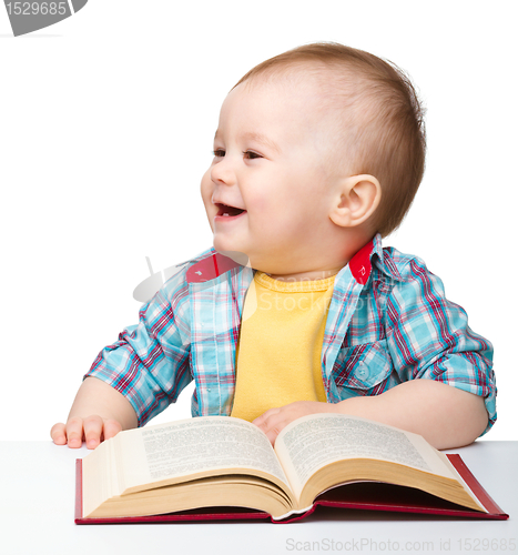 Image of Little child play with book