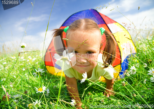 Image of Girl is playing outdoors under tent