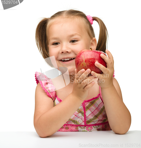 Image of Portrait of a little girl with apple