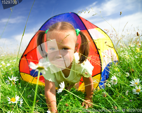 Image of Girl is playing outdoors under tent