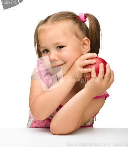 Image of Portrait of a little girl with apple