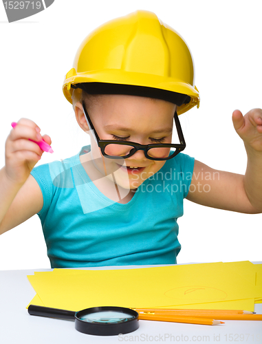 Image of Cute little girl draw with marker wearing hard hat