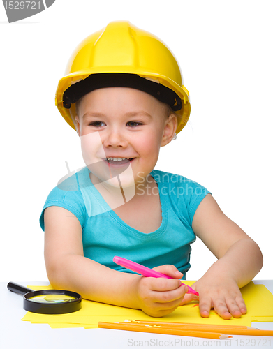 Image of Cute little girl draw with marker wearing hard hat