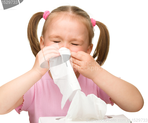 Image of Little girl blows her nose