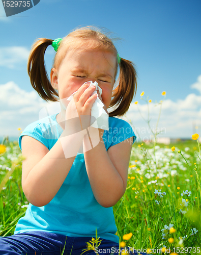 Image of Little girl is blowing her nose