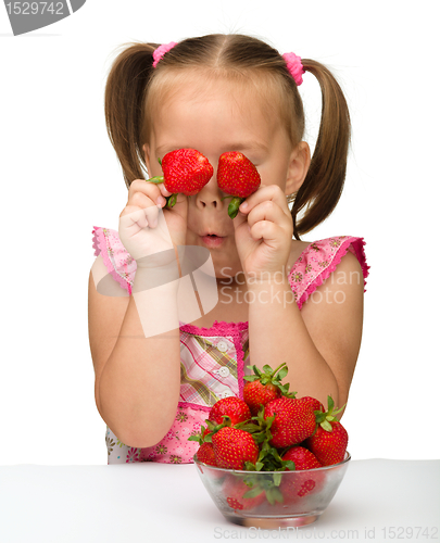 Image of Happy little girl with strawberries