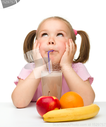 Image of Little girl drinks fruit juice