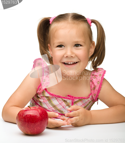 Image of Portrait of a little girl with apple