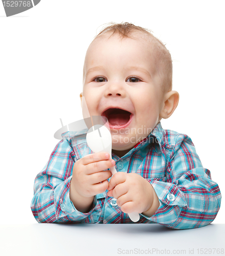 Image of Cute little boy with white spoon