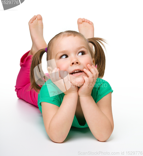 Image of Portrait of a cute little girl laying on floor