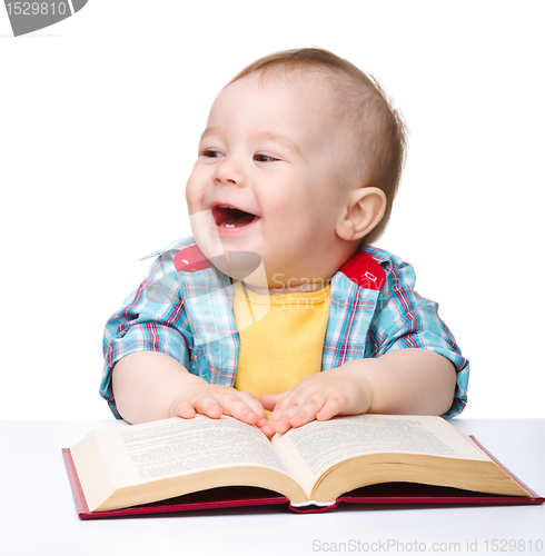 Image of Little child play with book