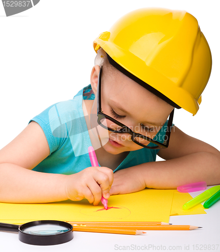 Image of Cute little girl draw with marker wearing hard hat