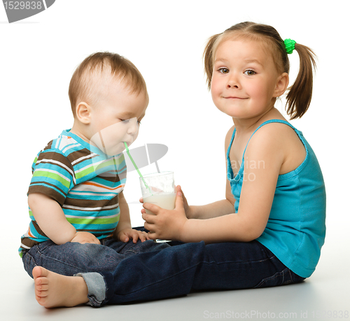 Image of Sister is feeding her little brother