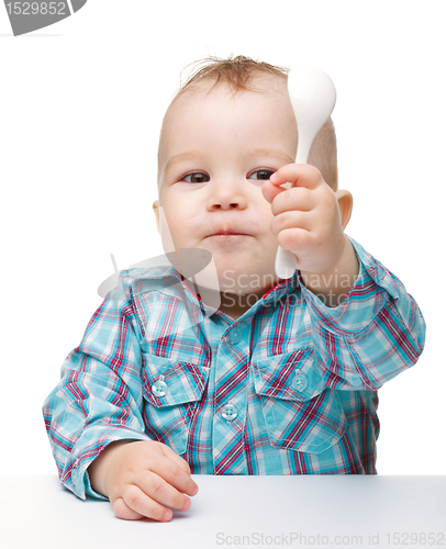 Image of Cute little boy with spoon