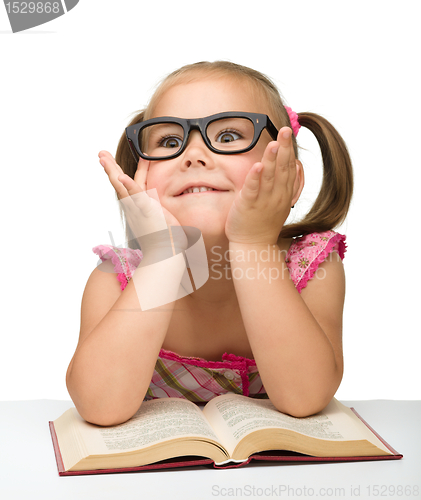 Image of Little girl play with book