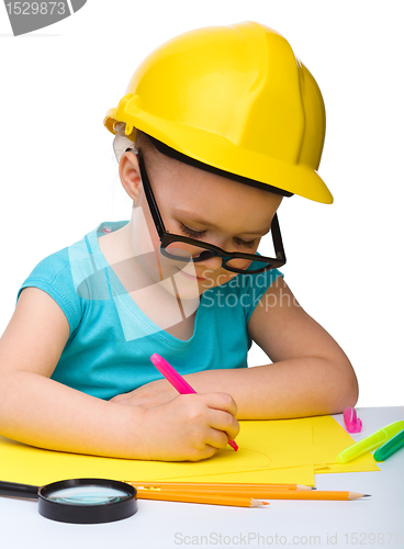 Image of Cute little girl draw with marker wearing hard hat