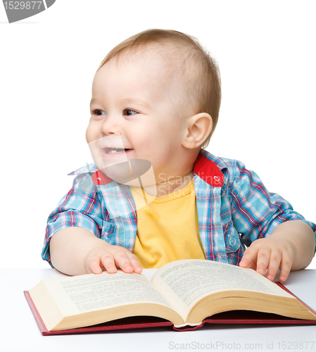 Image of Little child play with book