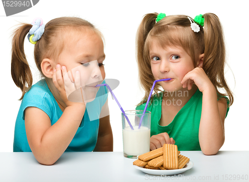 Image of Two little girls are drinking milk