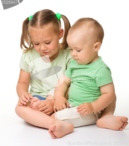 Image of Two children are playing on the floor