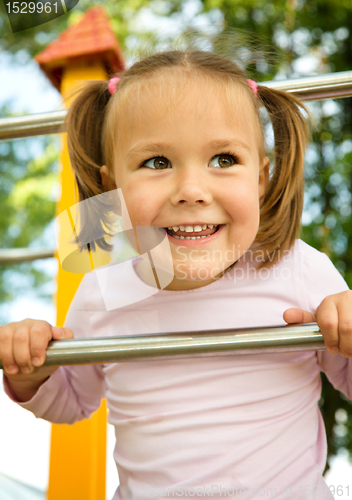 Image of Little girl is playing in playground