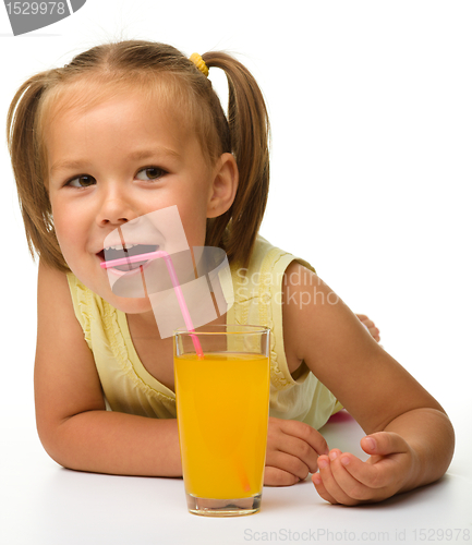 Image of Little girl drinks orange juice
