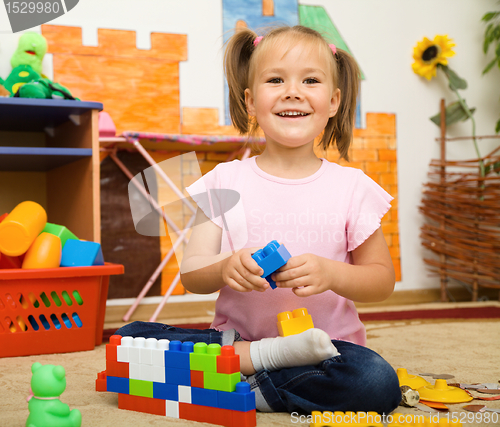 Image of Little girl is playing with toys in preschool