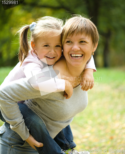 Image of Mother and her child are playing in park