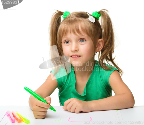 Image of Cute little girl draws with markers