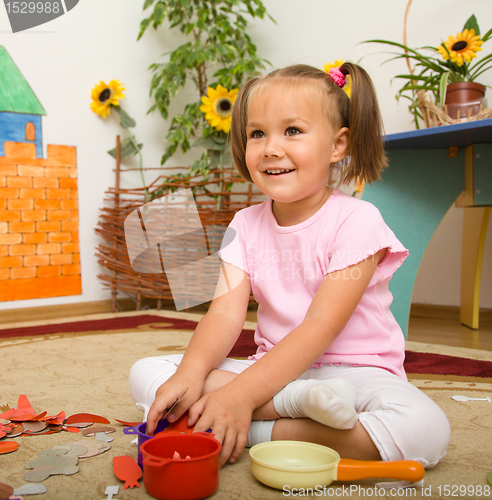 Image of Little girl is playing in preschool