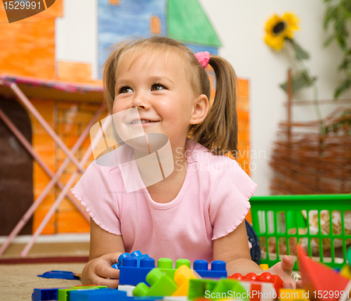 Image of Little girl is playing with toys in preschool