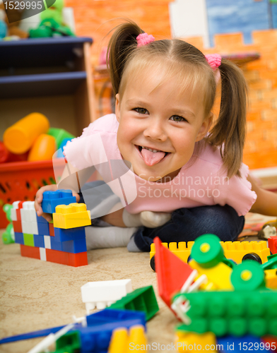 Image of Little girl is playing with toys in preschool