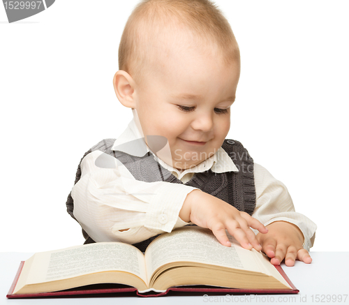 Image of Little child play with book