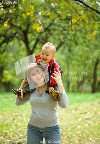 Image of Mother and her child are playing in park