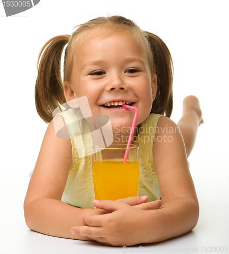 Image of Little girl drinks orange juice