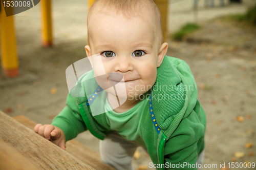 Image of Little boy is playing on playground