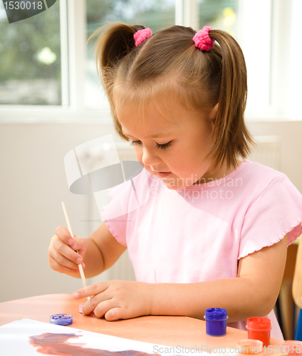 Image of Little girl is play with paints