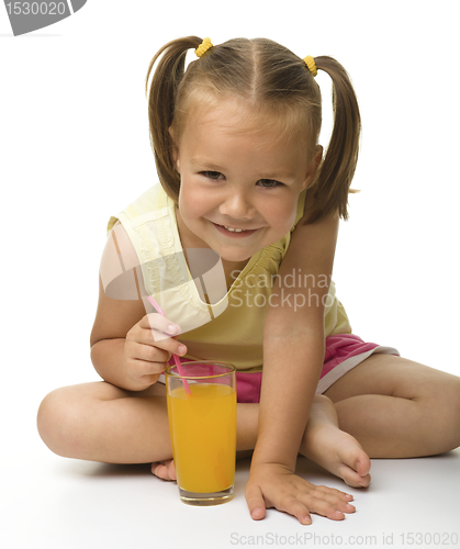 Image of Little girl drinks orange juice