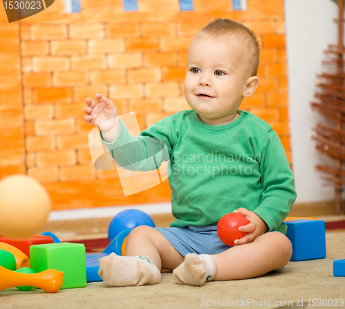 Image of Little boy is playing with toys in preschool