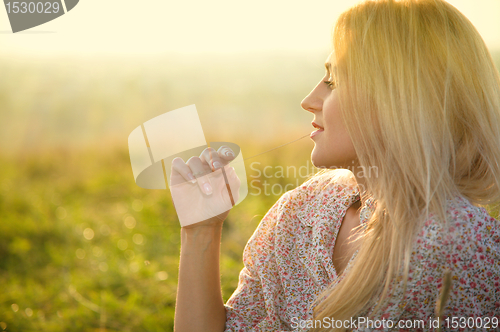Image of Girl is relaxing on green field