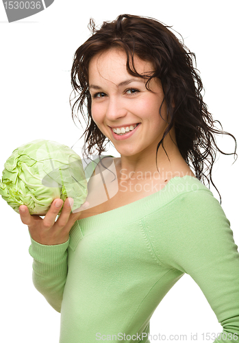 Image of Beautiful young girl with green cabbage
