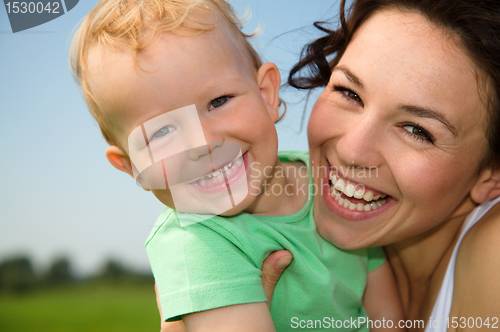 Image of Child with mother play outdoors