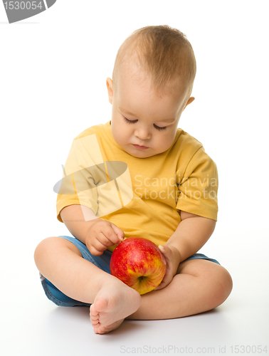 Image of Cute little boy with red apple