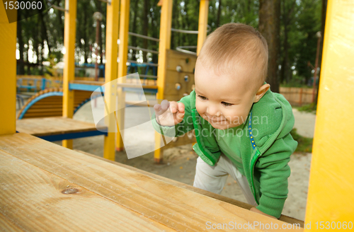 Image of Little boy is playing on playground