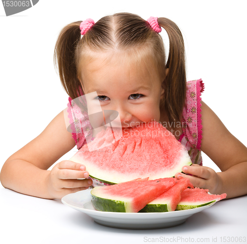 Image of Cute little girl is going to eat watermelon